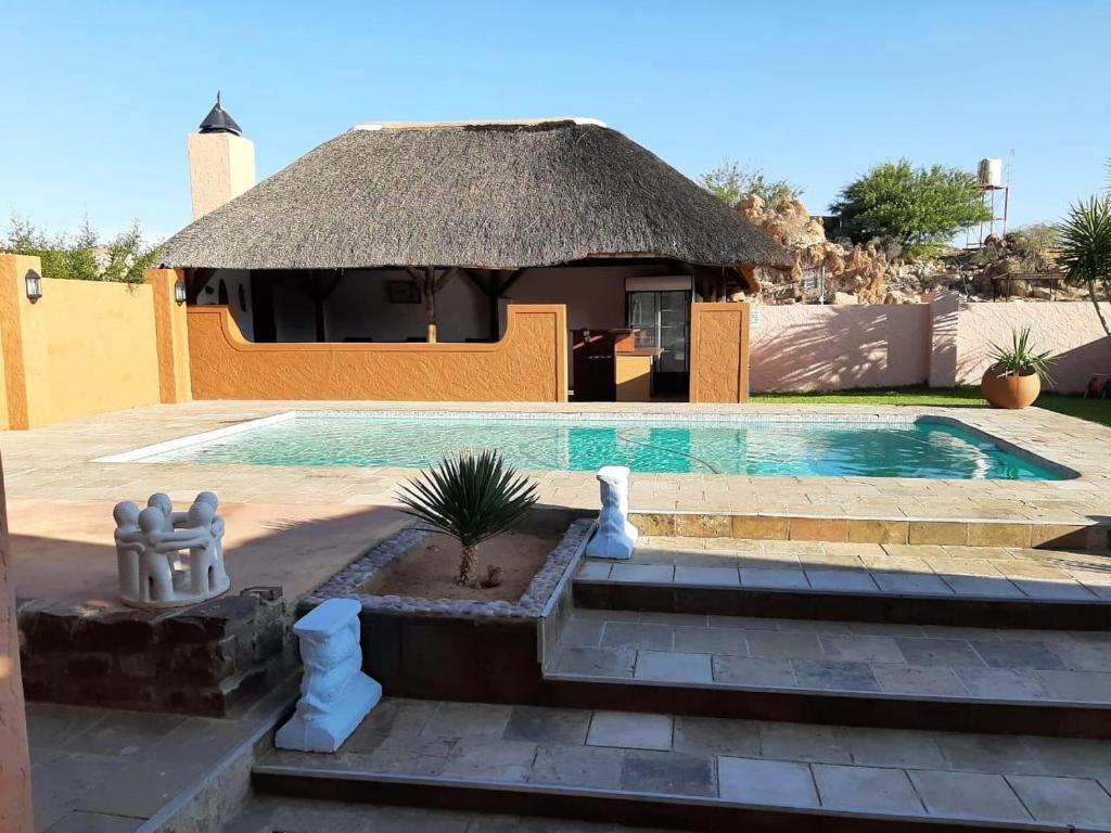 Goibib Mountain Lodge: strohgedeckte Lodge und Swimmingpool