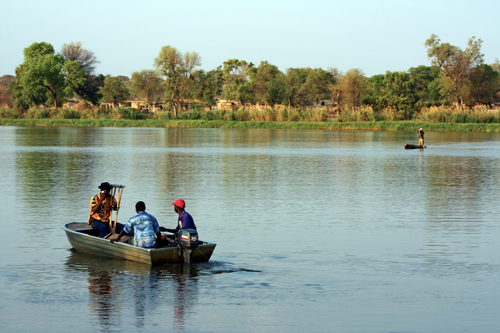 Boote überqueren den Kavango, der bei Nkurenkuru und Cuangar die Grenze zwischen Namibia und Angola bildet